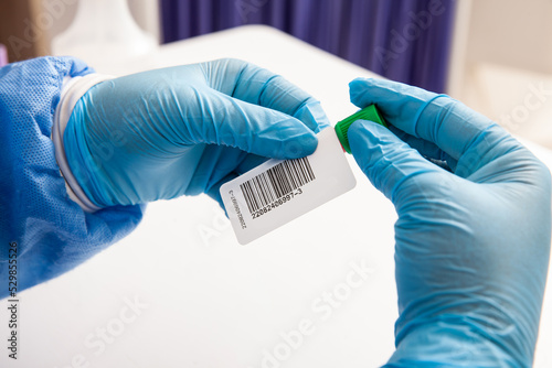 Closeup of a nurse labelling a test tube with blood sample in a clinical laboratory