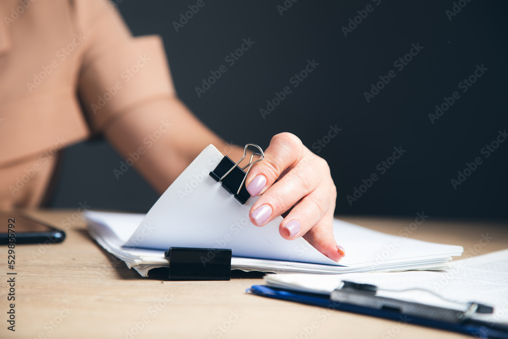 Fototapeta premium woman hands working in Stacks paper files