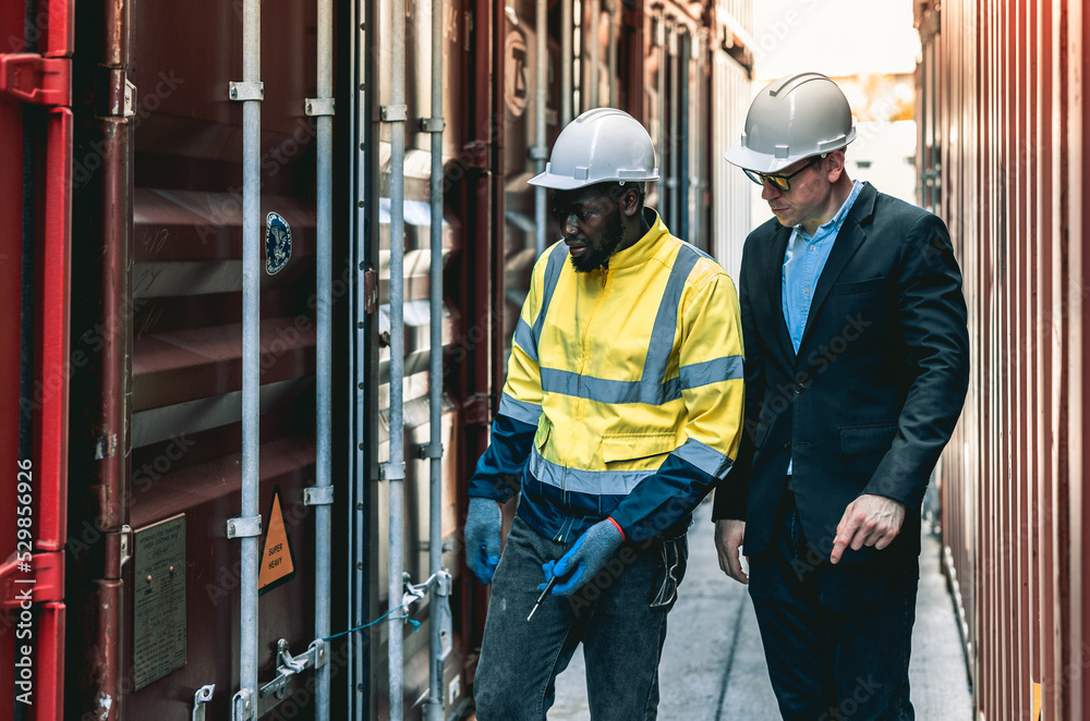 Container operator showing his boss the problem with the container while working in container yards. Container operator showing his boss the problem with the container while working in container yards.