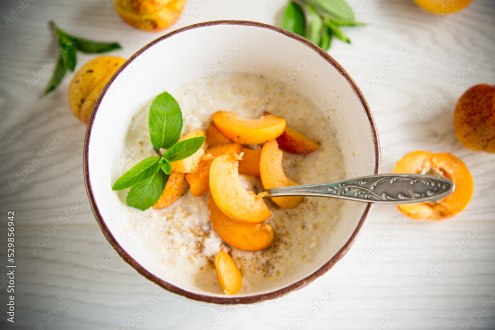 Healthy breakfast of apricot oatmeal with fresh fruit Healthy breakfast of apricot oatmeal with fresh fruit