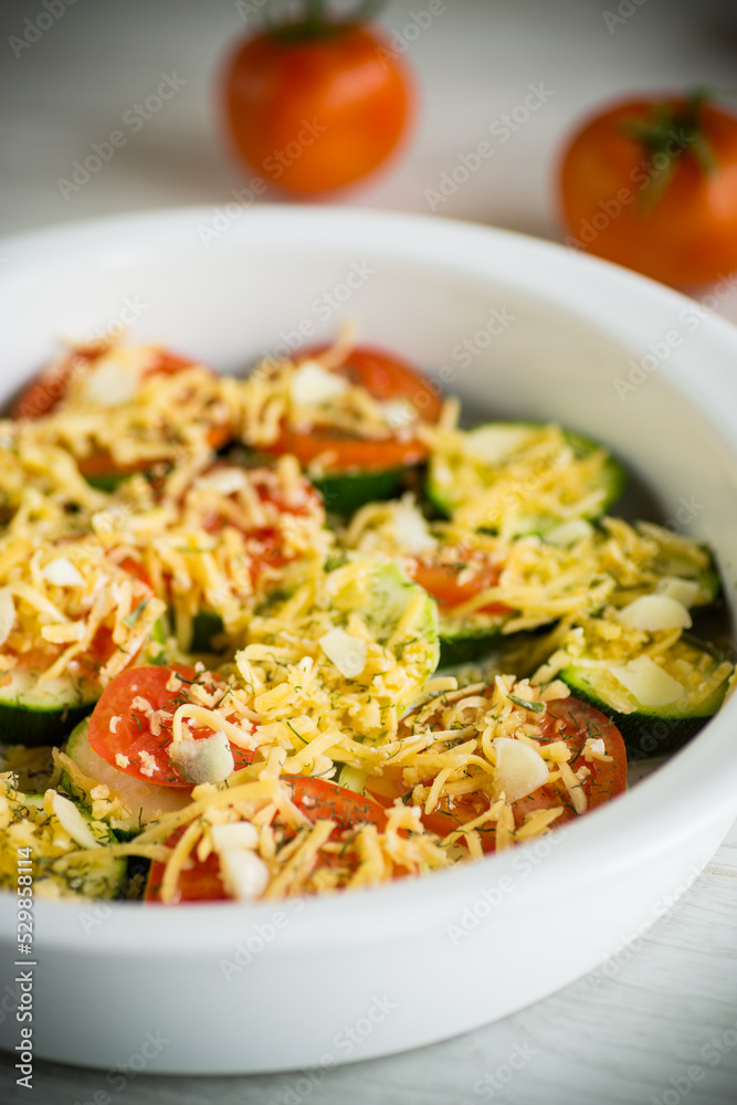 raw zucchini and tomatoes sliced with cheese, prepared for baking raw zucchini and tomatoes sliced with cheese, prepared for baking