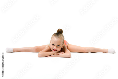 Small female gymnast lay in split down © o_lypa