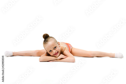 Small female gymnast lay in split down