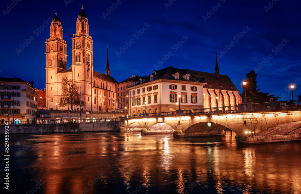 Panorama  image of evening Zurich. Night long exposure image of the Grossmunster Romanesque-style Protestant church in Zurich, Switzerland. Popular travel dectination.