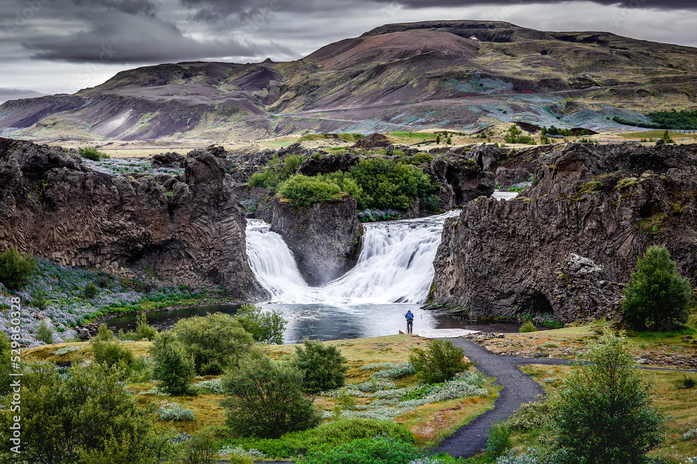 Popular Hjalparfoss waterfall in overcast weather in Iceland. Best famous travel area. Scenic Image of Iceland. Iceland is one most popular country for landscape photographers