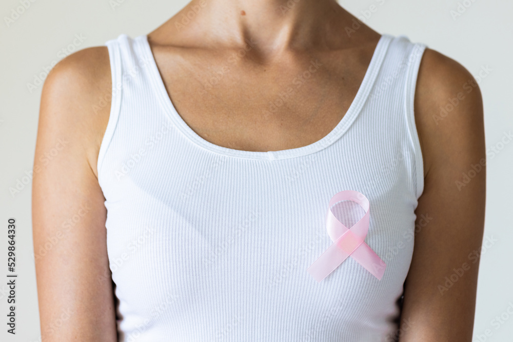 Woman with pink ribbon symbol of breast cancer awareness month. Woman with pink ribbon symbol of breast cancer awareness month.