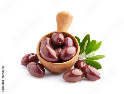 Kalamata olives with leaves in wooden spoon on white background photo
