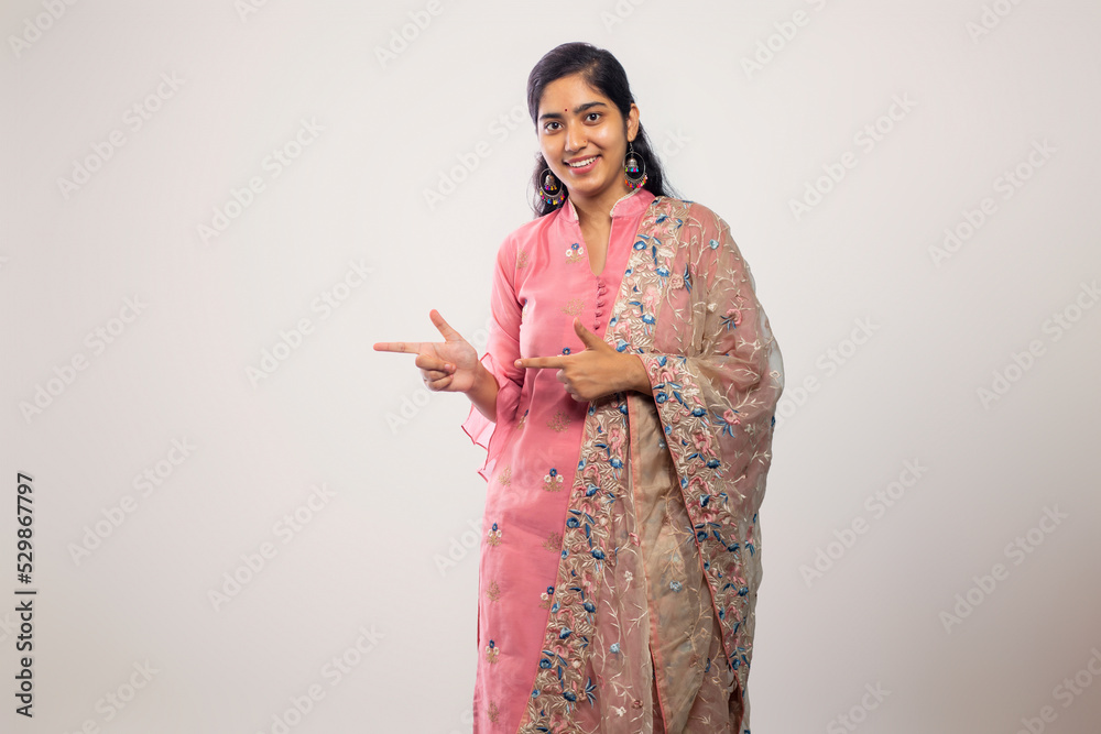 young Teenager girl smiling and pointing sideways young Teenager girl smiling and pointing sideways