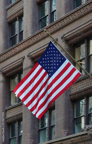 American flag flying on an old fashioned, ornate office building