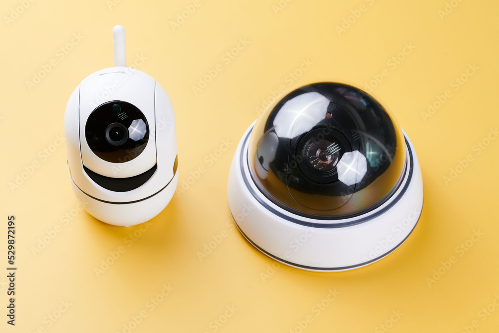 Surveillance cameras, set of different videcam, cctv cameras isolated on yellow background close up. home security system concept Surveillance cameras, set of different videcam, cctv cameras isolated on yellow background close up. home security system concept