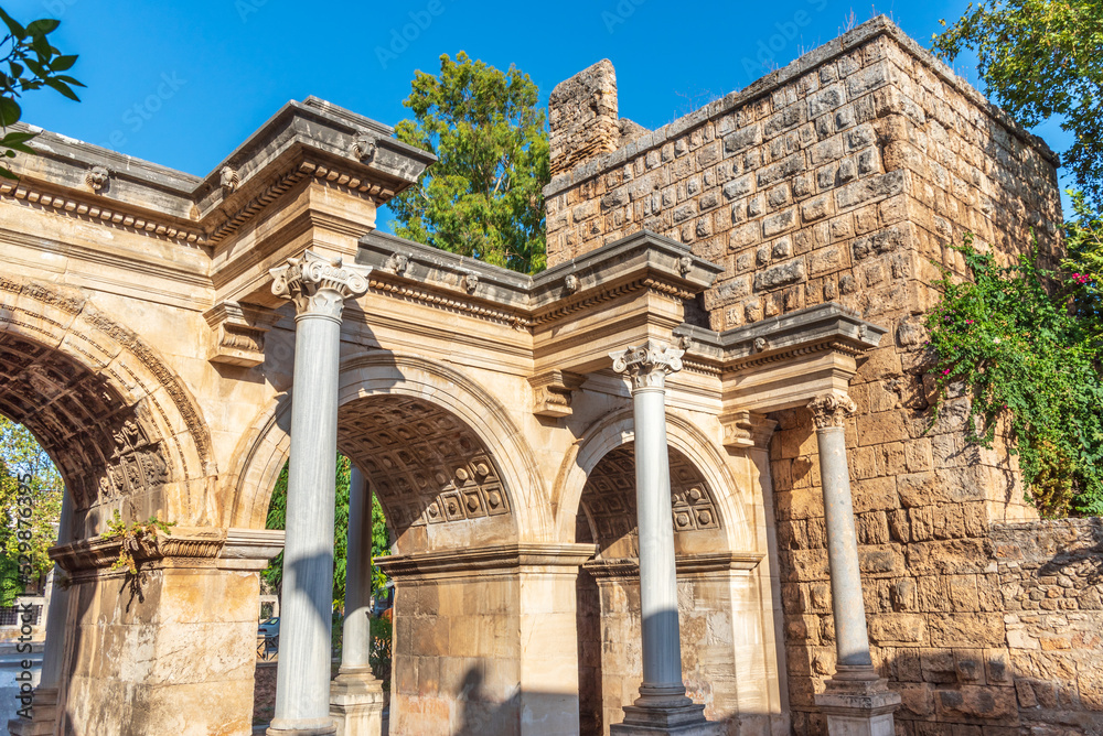 Popular tourist attraction - ancient Roman Hadrian Gate in old town Antalya (Turkey) on a summer day