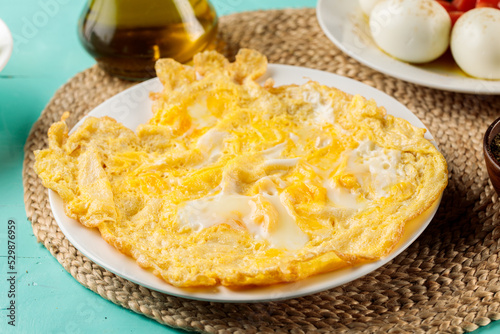Eggs Omelette served in dish isolated on wooden table side view of middle eastern food