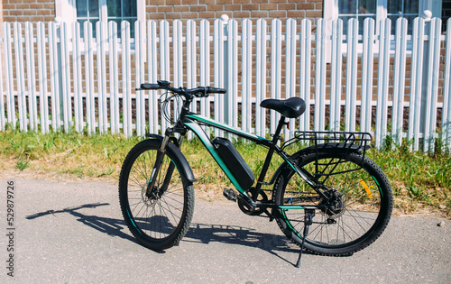 Electric bike in summer on a sunny day. E-bike is a modern hybrid vehicle