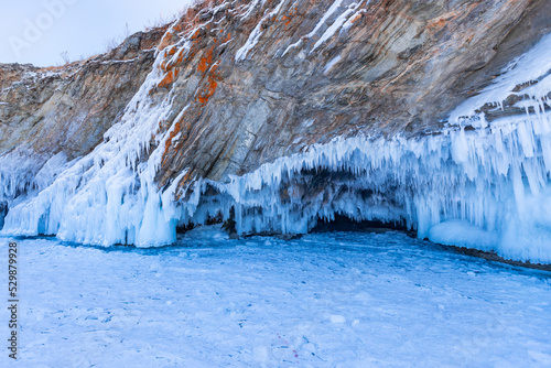 Winter landscape frozen lake Baikal and ice caves and grottoes on sunny day