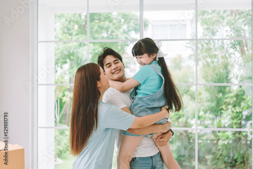 Portrait of young happy asian family spending time together at living room. © Platoo Studio
