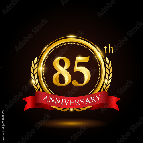 85th golden anniversary template design, with shiny ring and red ribbon, laurel wreath isolated on black background, logo vector