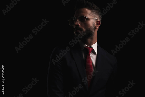 elegant businessman with glasses looking to side