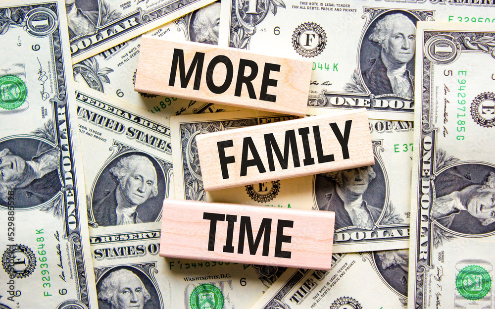 More family time and support symbol. Concept words More family time on wooden blocks on dollar bills. Beautiful background from dollar bills. Business, more family time qoute concept. Copy space.