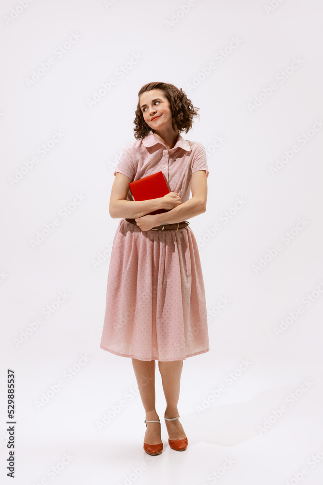Portrait of cute brunette woman with day makeup posing with book isolated over white background. Dreamy look Portrait of cute brunette woman with day makeup posing with book isolated over white background. Dreamy look