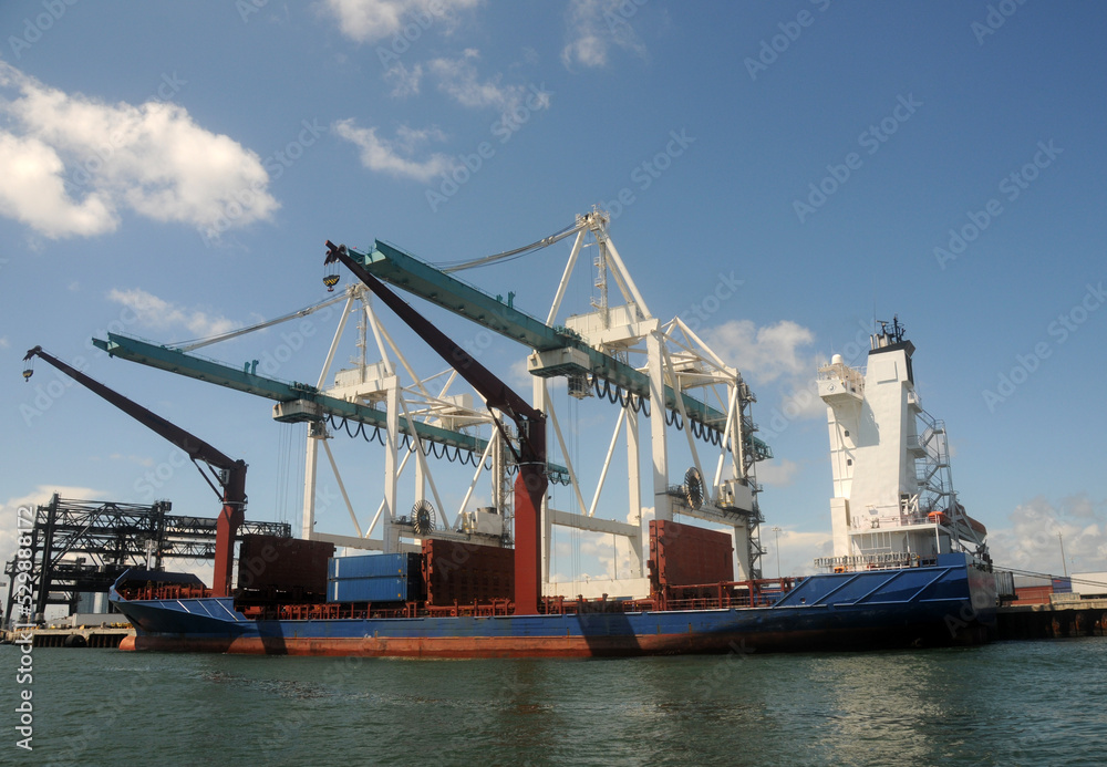 Cargo ship loading in industrial port