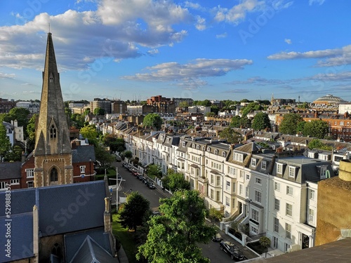 Photography Road between an old church and a row of houses in Chelsea, London