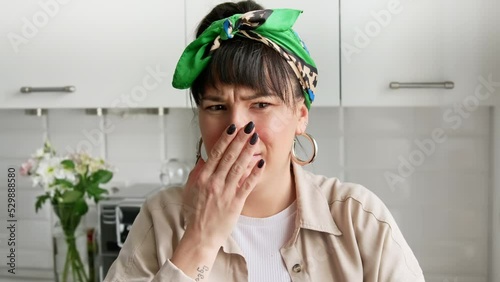 Repulsion to bad smell. Unhappy woman spins her nose, smells something awful. Spoiled air.