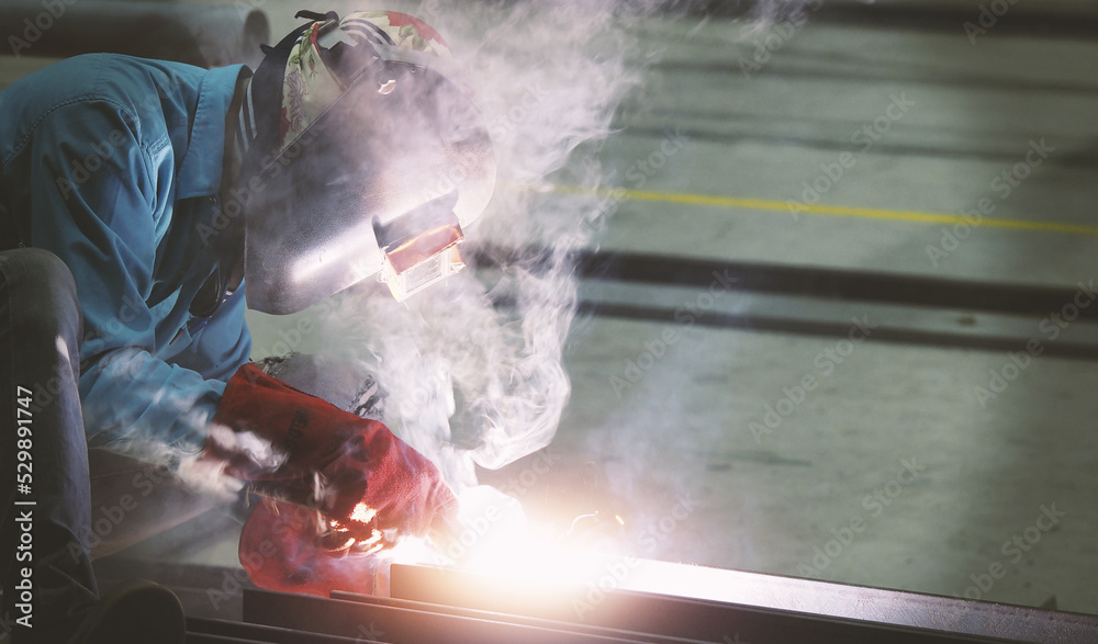 Welders are welding structural steel using Flux Core welding machines