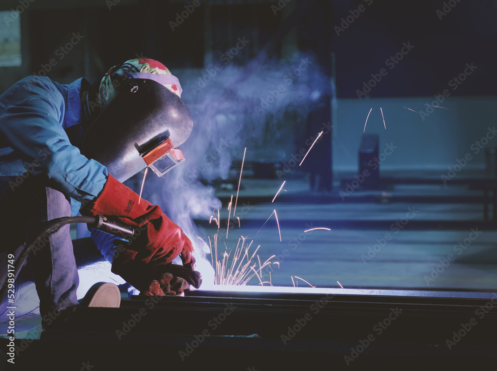 Welders are welding structural steel using Flux Core welding machines