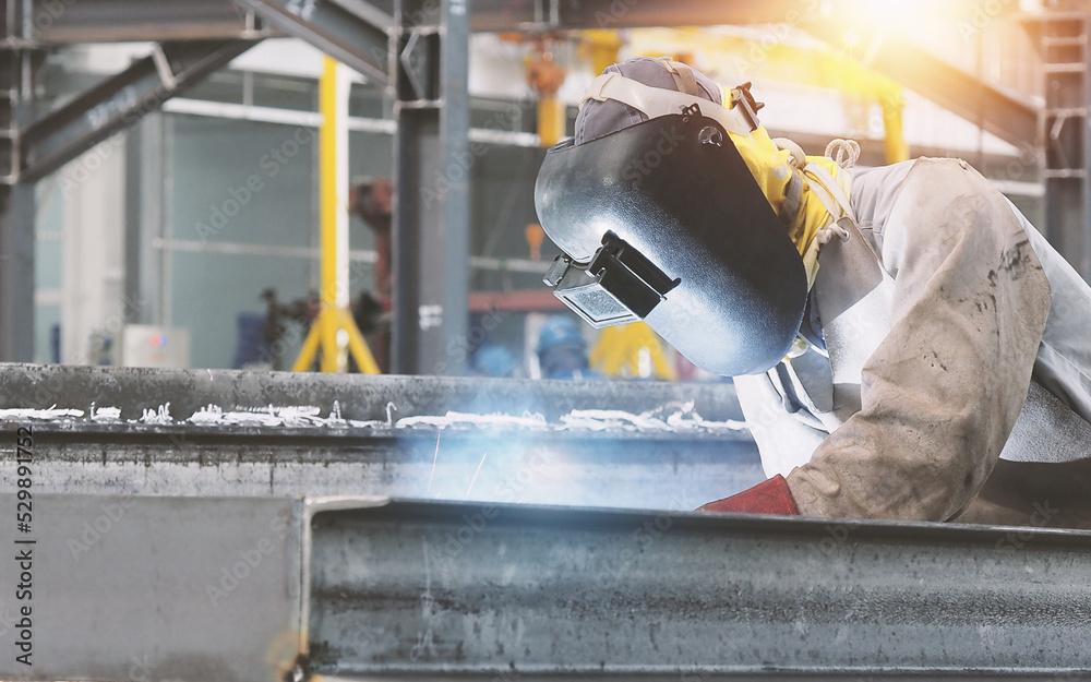 Welders are welding structural steel using Flux Core welding machines