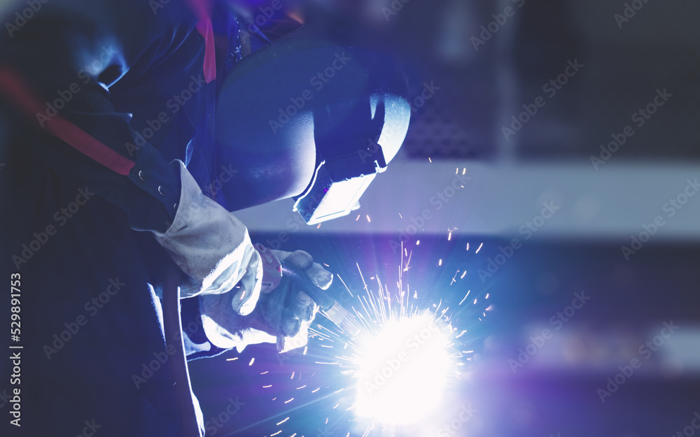 Welders are welding structural steel using Flux Core welding machines