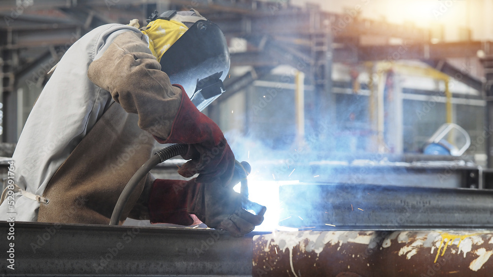 Welders are welding structural steel using Flux Core welding machines
