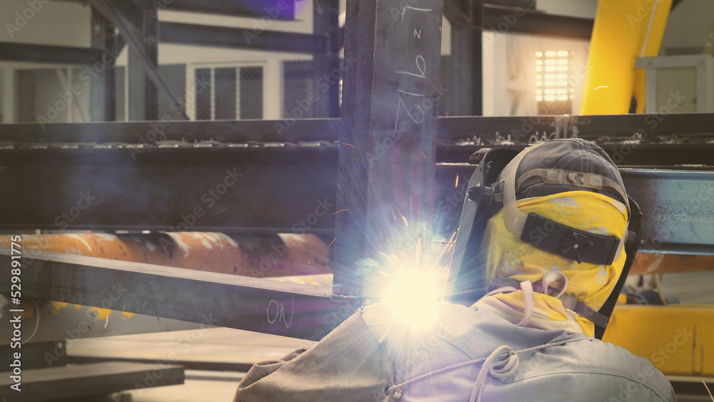 Welders are welding structural steel using Flux Core welding machines