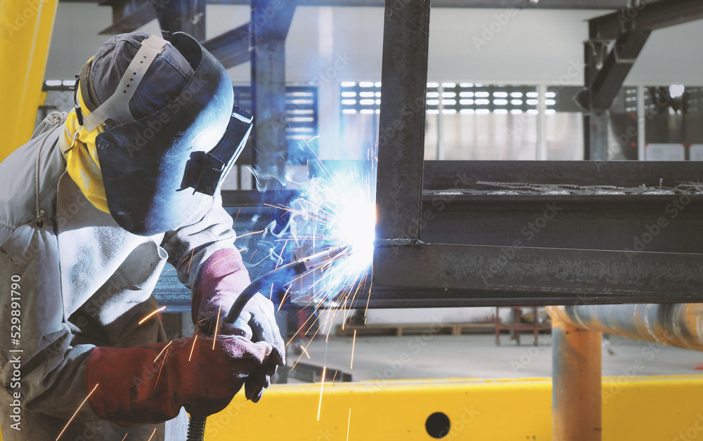 Welders are welding structural steel using Flux Core welding machines