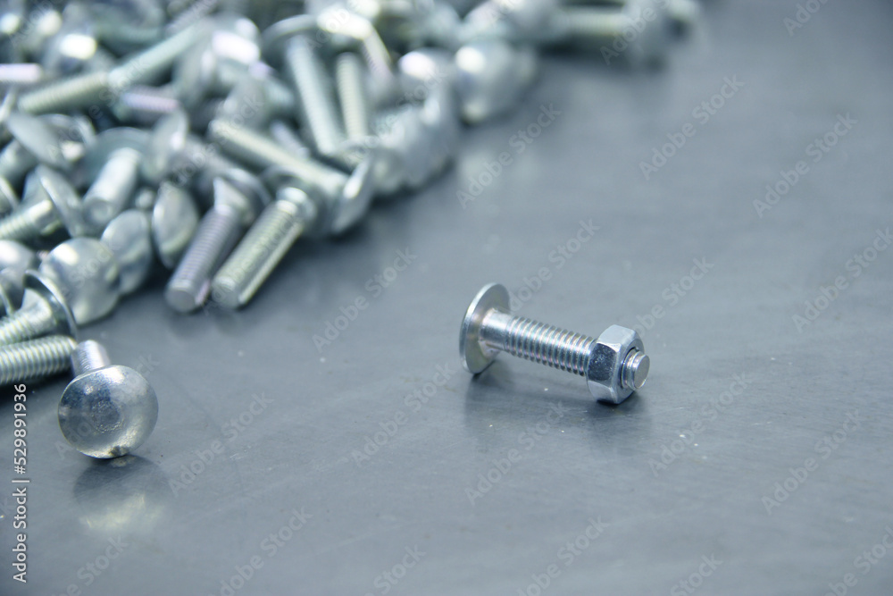 A set of various nuts, bolts, screws on the background of a steel plate. Locksmith business. A set of various nuts, bolts, screws on the background of a steel plate. Locksmith business.