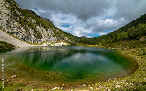 Beautiful panorama view of Schwarzensee lake near Tauplitzalm in Ausseerland region on a sunny summer day with blue sky cloud, Styria, Austria