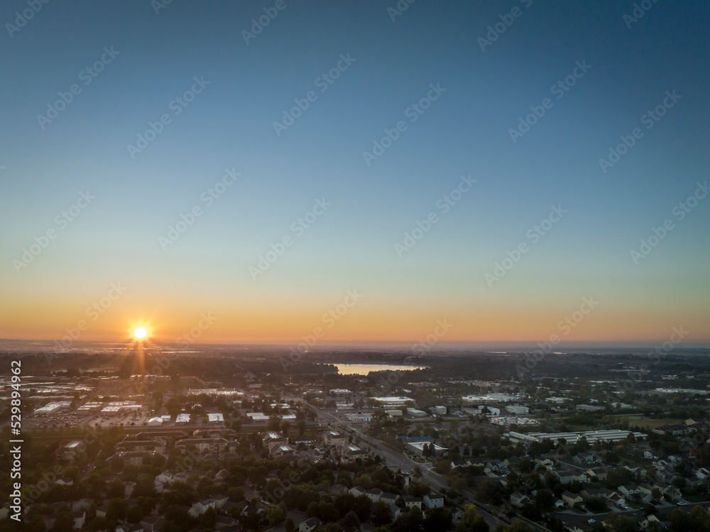 summer sunrise over plains and Fort Collins in northern Colorado, aerial view