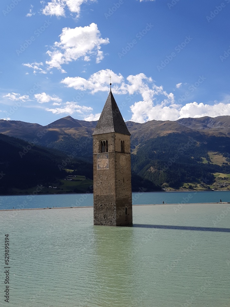 Tower of the sunken church in Lake Reschen/Resia Lake, Vinschgau Valley, South Tyrol, Italy.