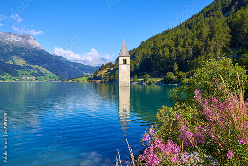 bell tower that comes out of the lake of resia, italy