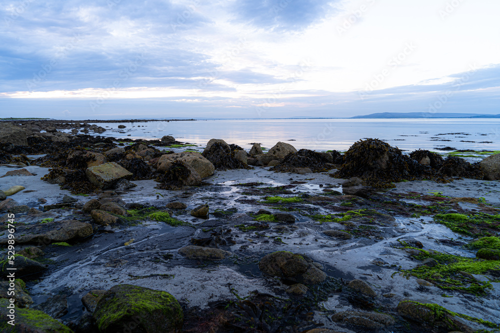 View on the North Atlantic Ocean from the beaches of Ireland near the city Galway in the morning, golden hour and blue hour. View on the North Atlantic Ocean from the beaches of Ireland near the city Galway in the morning, golden hour and blue hour.