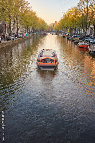 a boat cruising in the canal at Amsterdam 