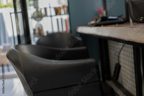 black barber chair in front of the mirror