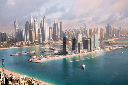 Photography Dubai Marina skyscrapers view at sunset with boats and yachts in the Persian gulf waters