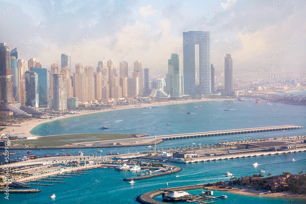  Dubai, UAE. Dubai Marina. Beaches  view at sunset with boats and yachts in the Persian gulf waters. Dubai, UAE.