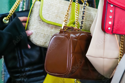 Woman chooses vintage handbag in second hand. Weekend flea market