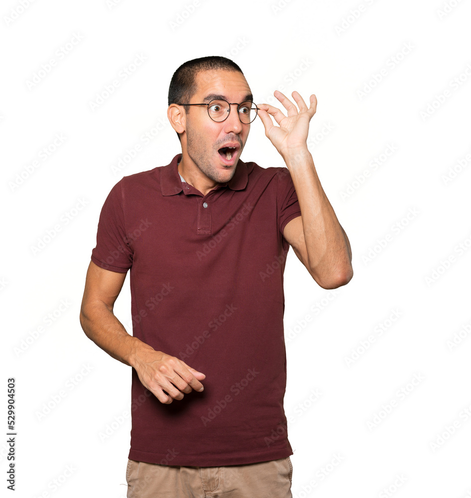 Astonished young man with a gesture of looking away Astonished young man with a gesture of looking away