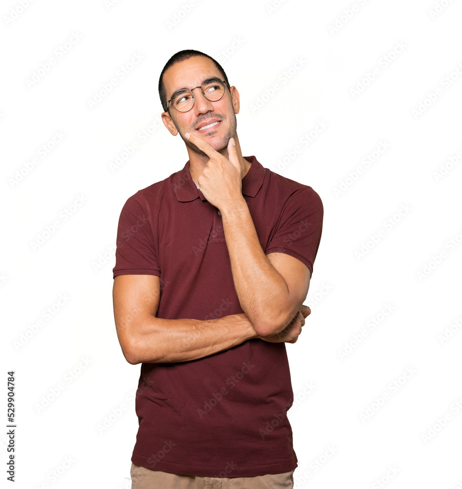 Happy young man making a gesture of doubt Happy young man making a gesture of doubt