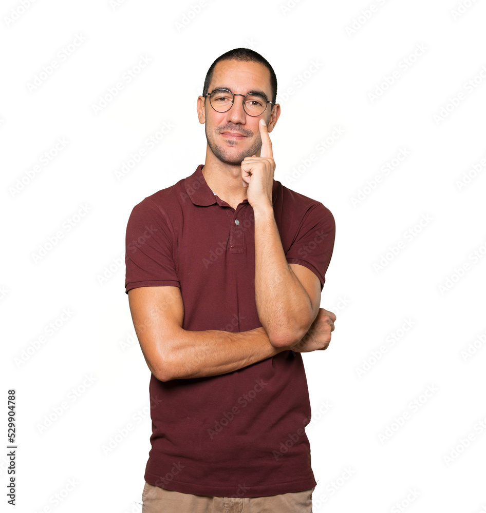 Happy young man making a gesture of doubt Happy young man making a gesture of doubt