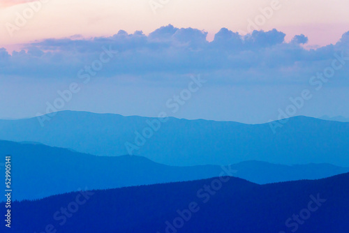 Misty mountain silhouettes.