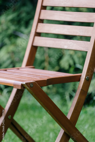 closeup of wooden chair outdoors on green background