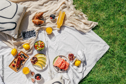 picnic on blanket with food at summer sunny day photo